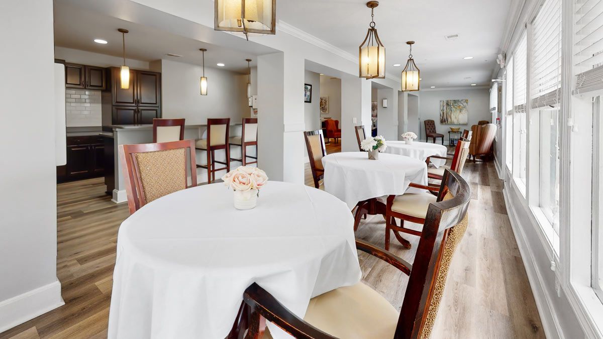 A well-decorated dining area with elegant lighting and neatly arranged tables and chairs.