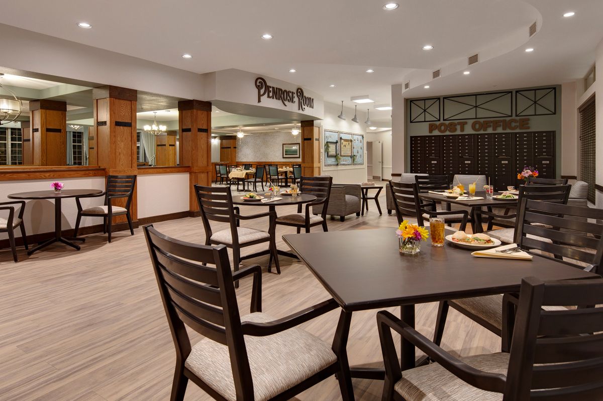 A modern indoor restaurant dining area with neatly arranged tables and chairs.