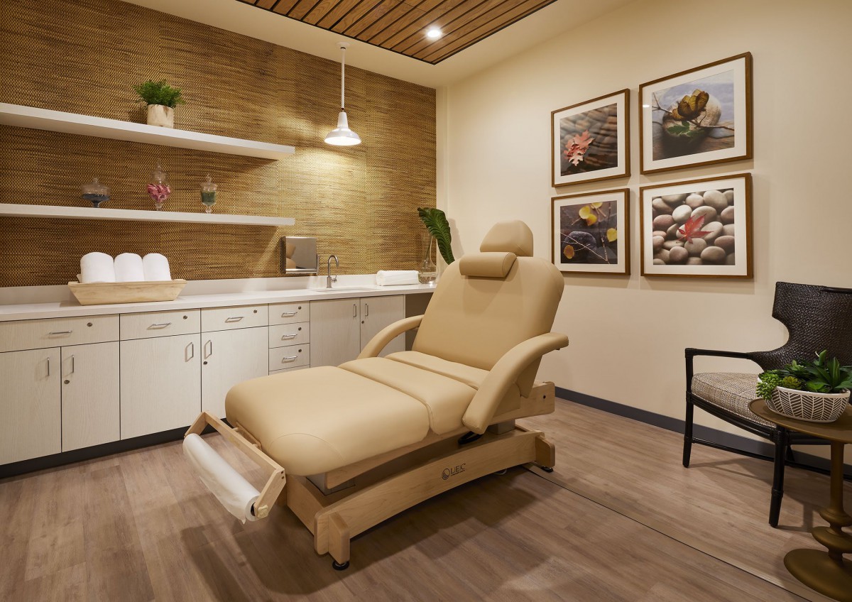 A serene and well-appointed massage room designed for relaxation and therapy.