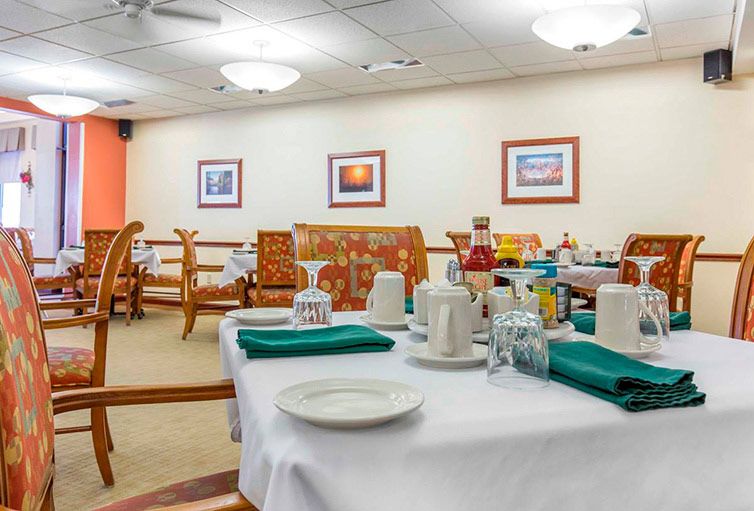 A cozy dining area with neatly set tables and colorful decorations.