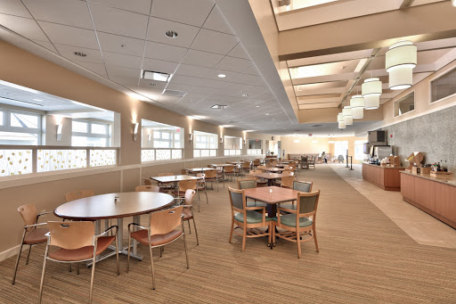 A spacious dining area featuring modern furniture and ample natural light.