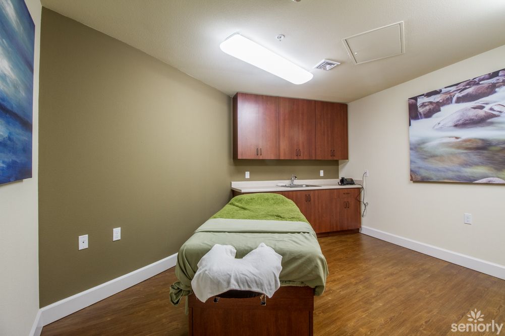 A tranquil massage room with a treatment bed ready for a relaxing spa session.