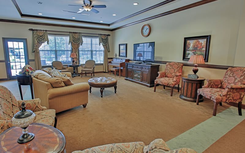 A cozy living room with a comfortable seating area and a large television.