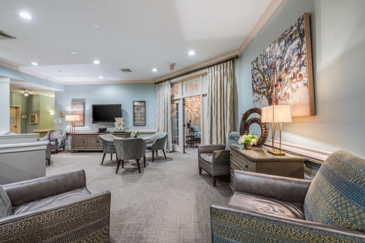 A stylish modern living room with elegant furniture, wall art, and soft lighting.