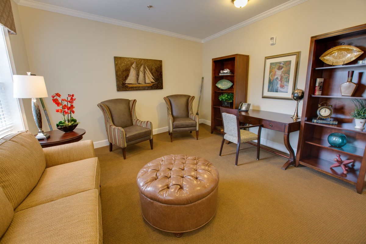 A cozy living room with elegant furniture and decorative elements.