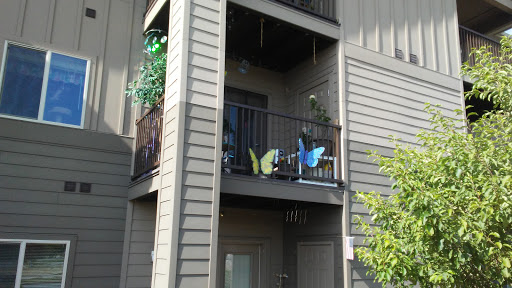 A charming apartment balcony adorned with decorative butterflies and greenery.