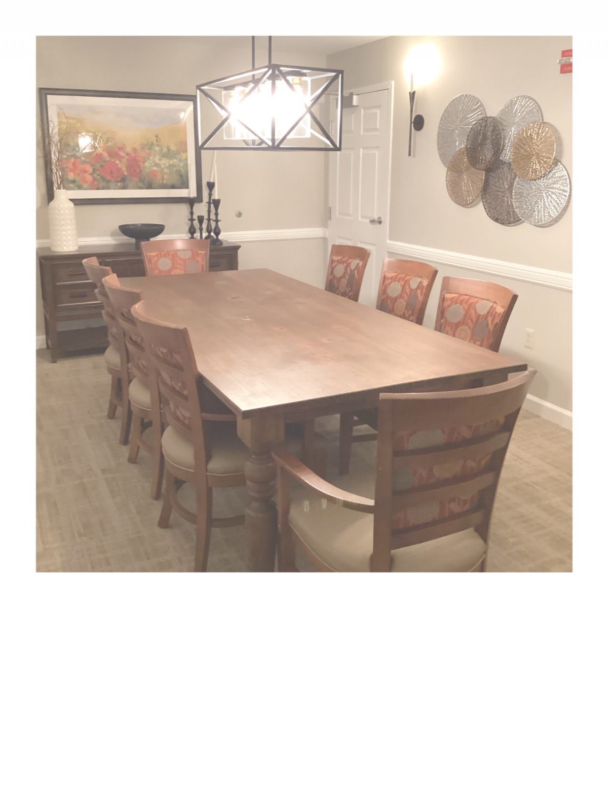A well-decorated dining room featuring a long wooden table and chairs.