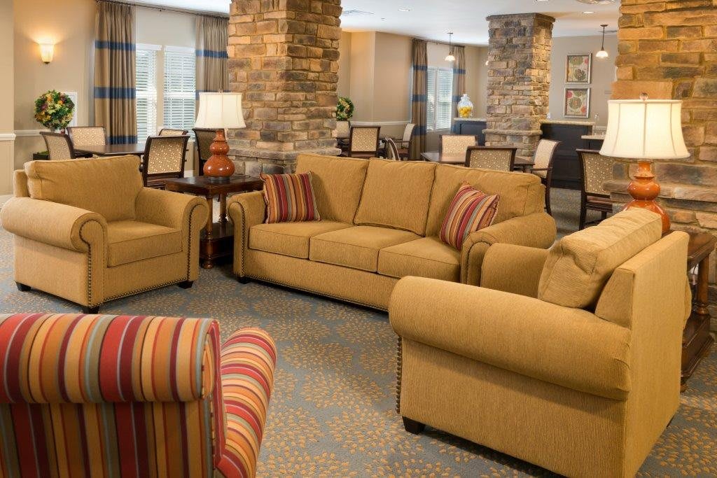A cozy living room with comfortable sofas and armchairs arranged in a welcoming space.