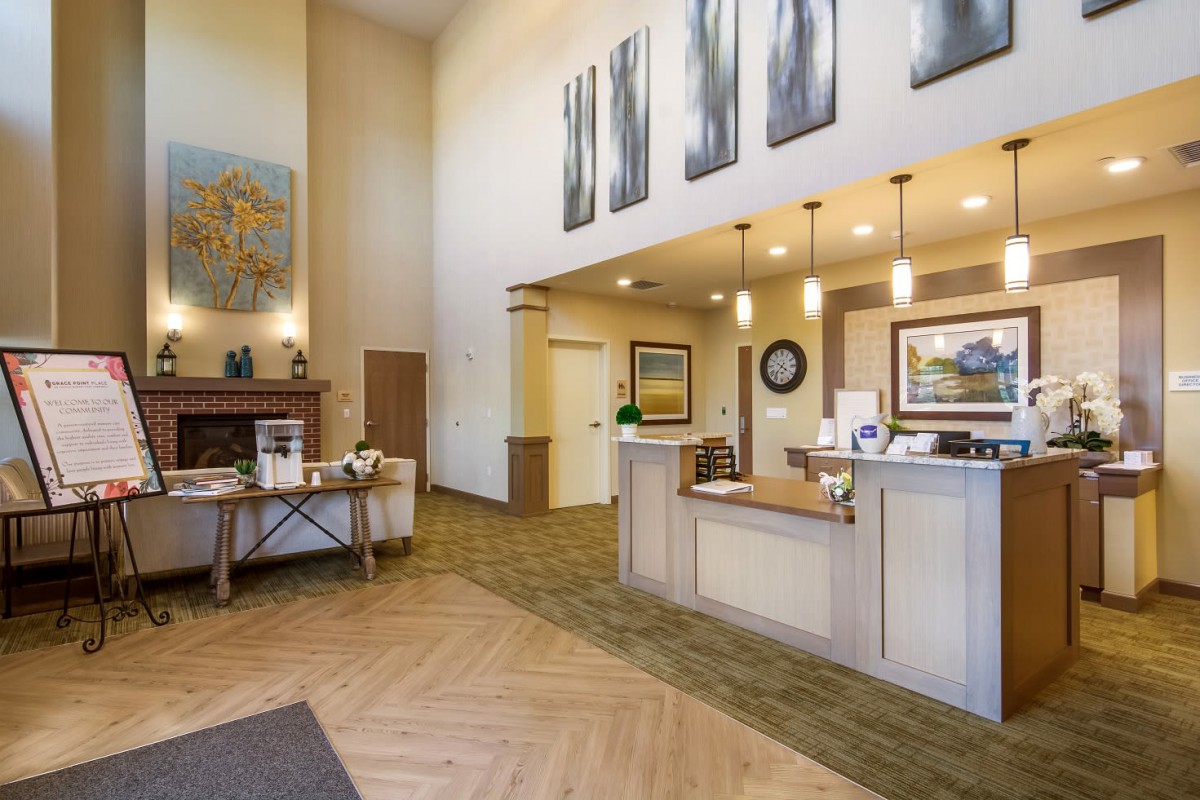 A welcoming reception area with a front desk, artwork on the walls, and comfortable lighting.