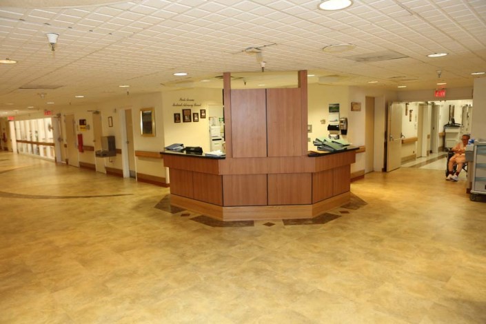A spacious hospital lobby featuring a central reception desk.