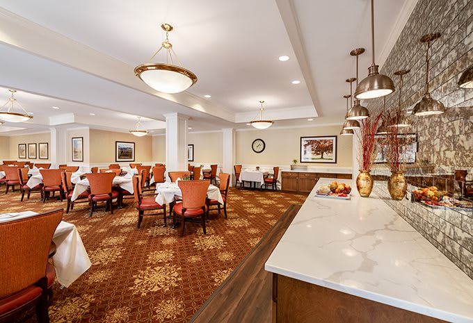 A well-lit dining room with elegant decor and comfortable seating.