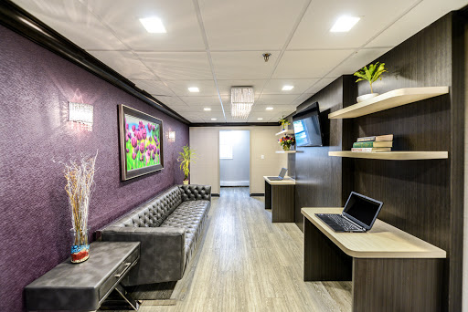 A modern and welcoming lobby featuring comfortable seating, vibrant artwork, and stylish decor.