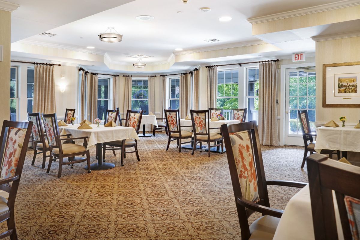 A cozy and elegantly furnished dining room with neatly arranged tables and chairs.