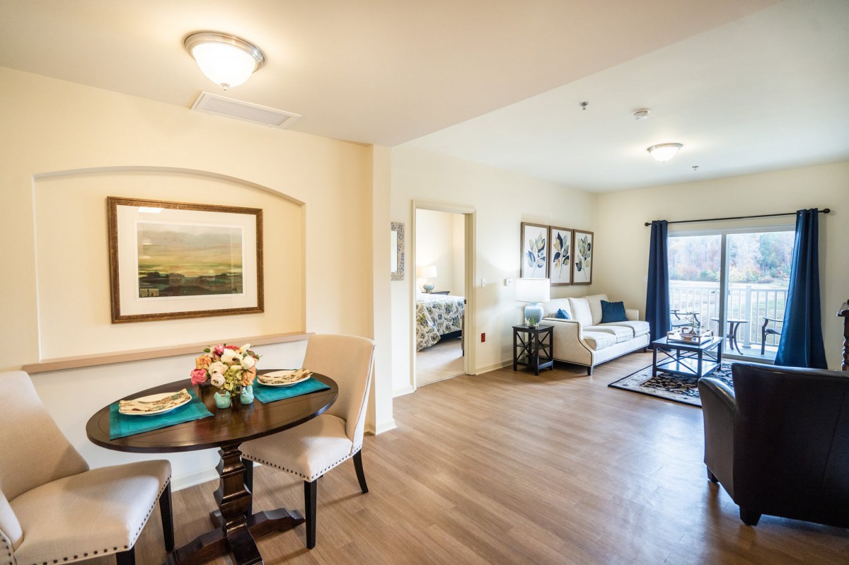 A cozy apartment interior featuring a living room and dining area with elegant decor.