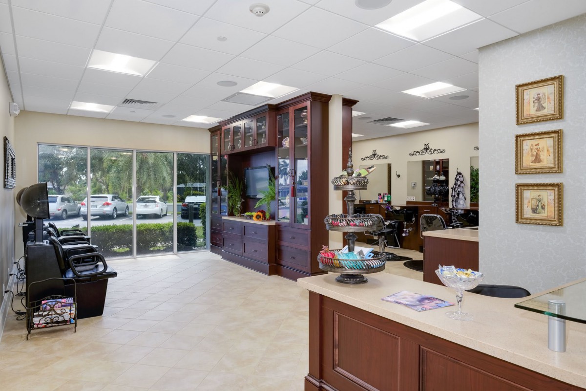 A modern and bright salon interior with a reception area and stylish furniture.
