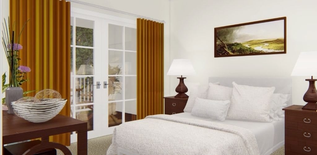 Cozy bedroom with a neatly made bed, bedside lamp, and sliding glass doors.
