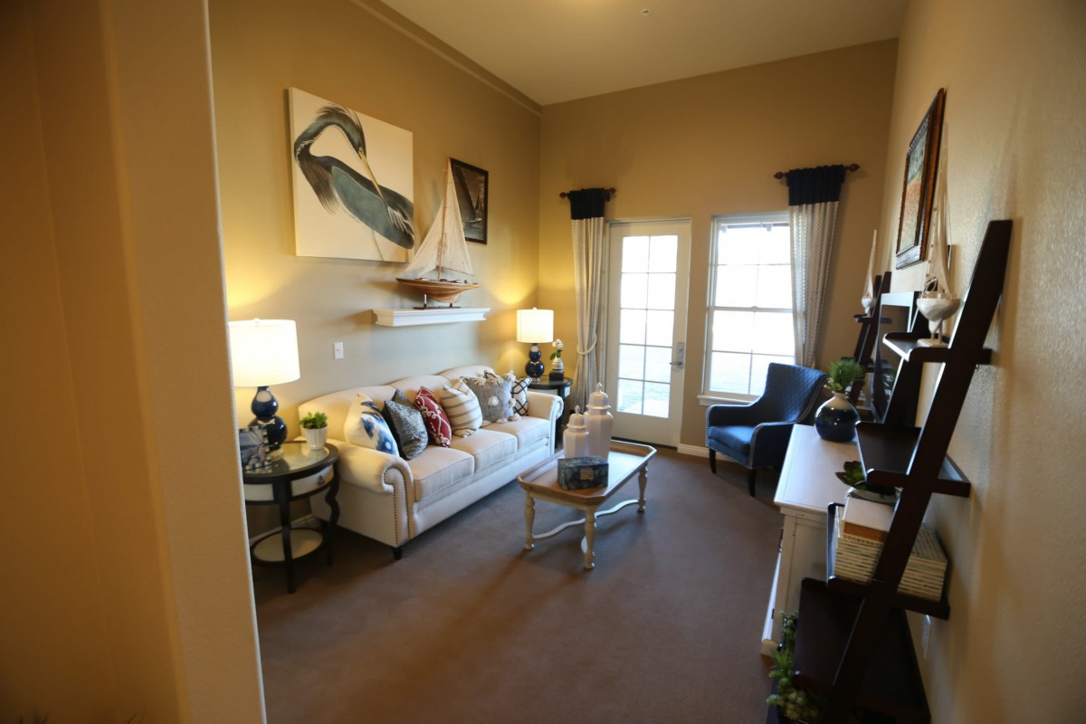 A cozy living room with comfortable seating, decorative pillows, and tasteful artwork.