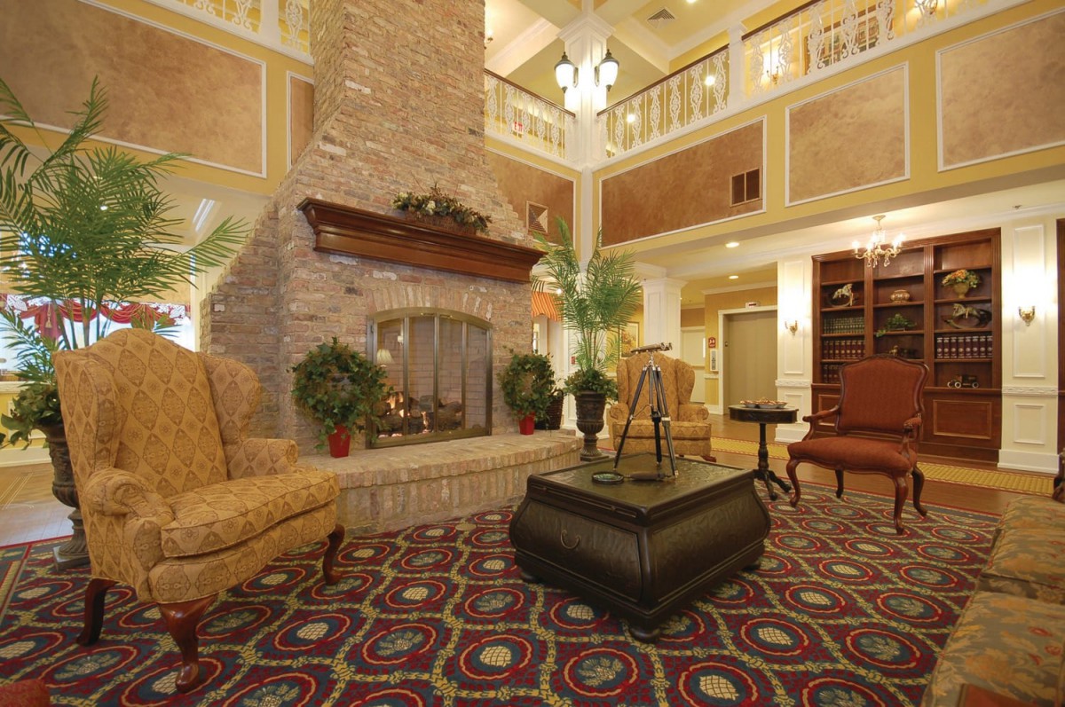 A cozy hotel lobby with a fireplace and comfortable seating.