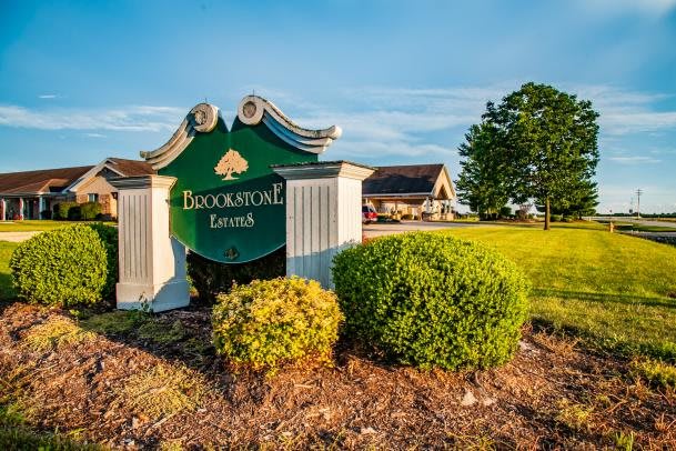Entrance sign to a picturesque golf course surrounded by lush greenery.