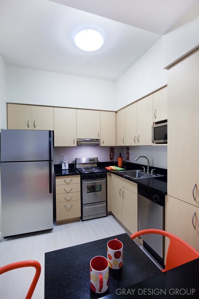 A modern kitchen with stainless steel appliances and ample cabinet space.
