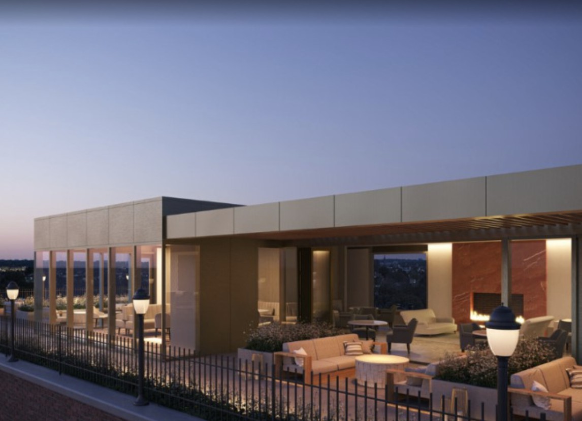 Modern rooftop seating area illuminated in the evening.
