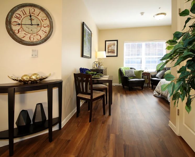 A cozy and minimalist living space with wooden flooring and tasteful decor.