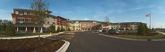 A hotel building with an adjacent parking lot.