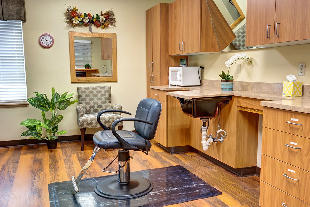A cozy hair salon interior with a barber chair, sink, and stylish decor.