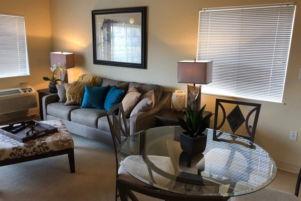 A cozy living room with a comfortable sofa, colorful throw pillows, and ambient lighting.