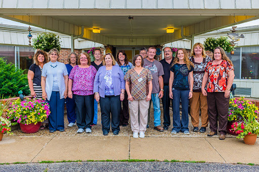 Staff members gather for a group photo outside the building.