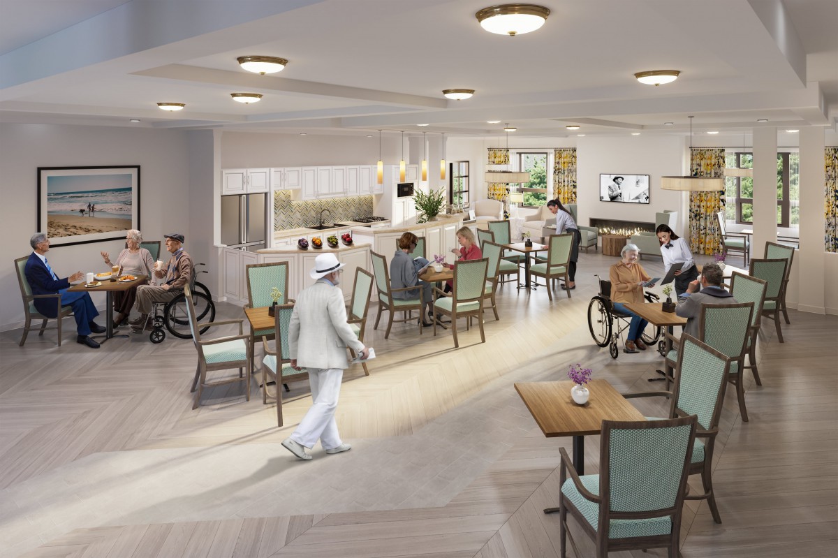 A well-lit dining area in an elderly care facility with residents and staff interacting.