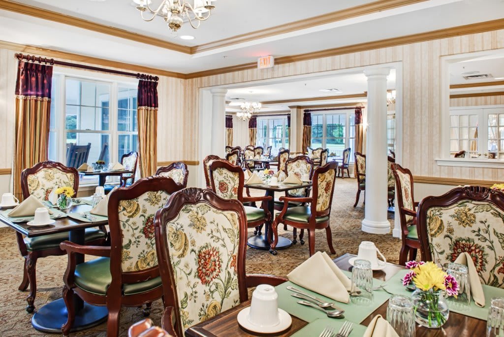 An elegantly decorated dining room with classic furniture and neatly set tables.