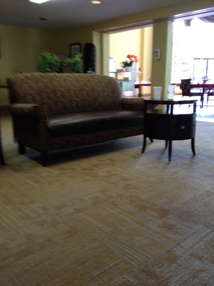 A comfortable waiting area with a sofa and a side table.