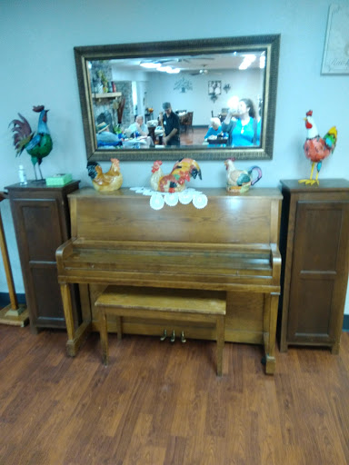 A beautifully arranged wooden piano with decorative accents and a mirror reflecting the surrounding interior.