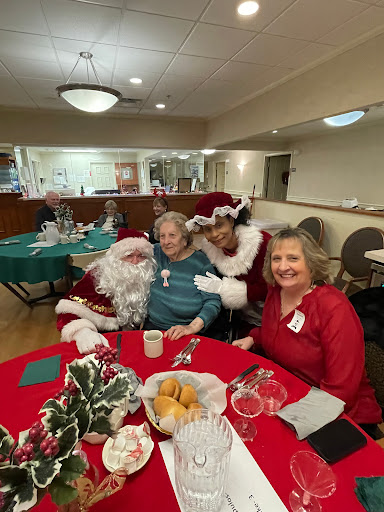 A joyful holiday gathering featuring Santa Claus and friends, celebrating the festive season together.