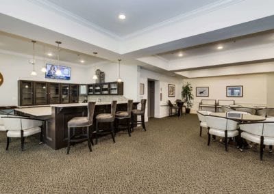 A modern lounge with a bar area and seating.