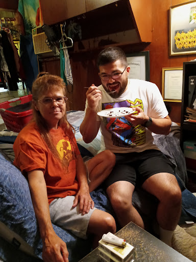 Two friends enjoying a moment together, one eating from a plate.