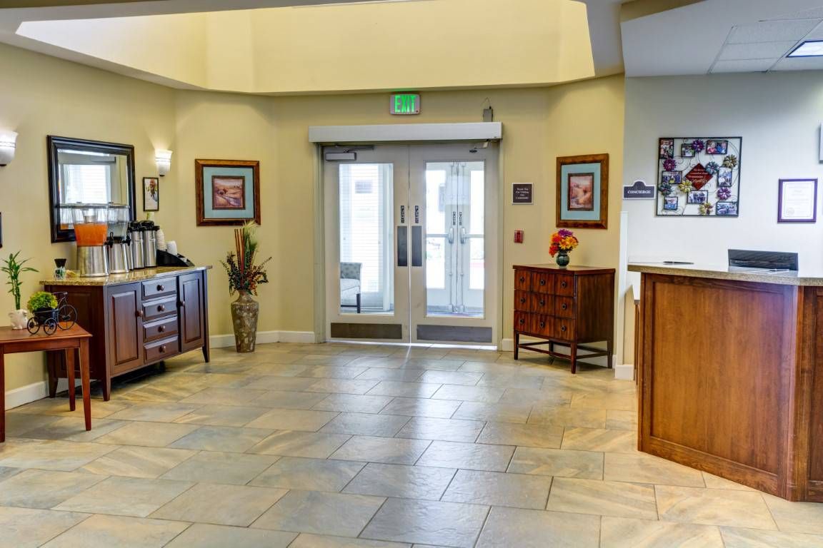 A well-lit lobby area with decorative furniture and tiled flooring.