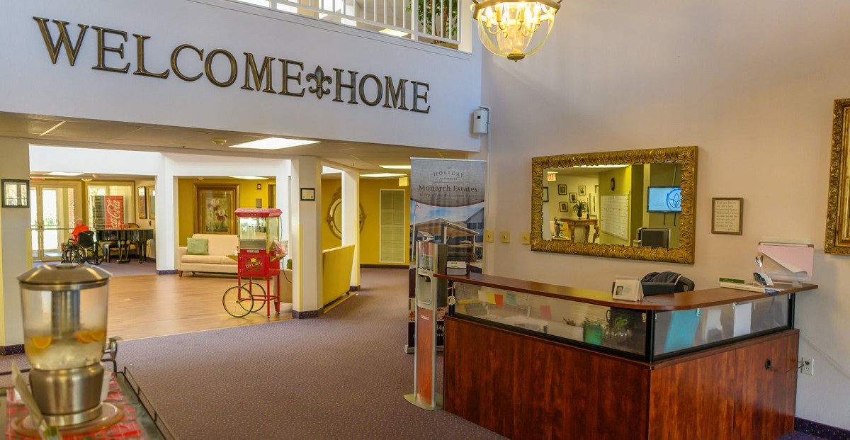 A welcoming lobby area with homey decor, featuring a reception desk and a popcorn machine.