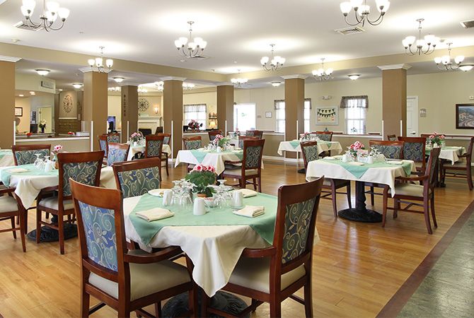 A well-arranged dining area with neatly set tables and chairs.