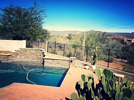 A serene outdoor pool surrounded by a beautiful desert landscape.