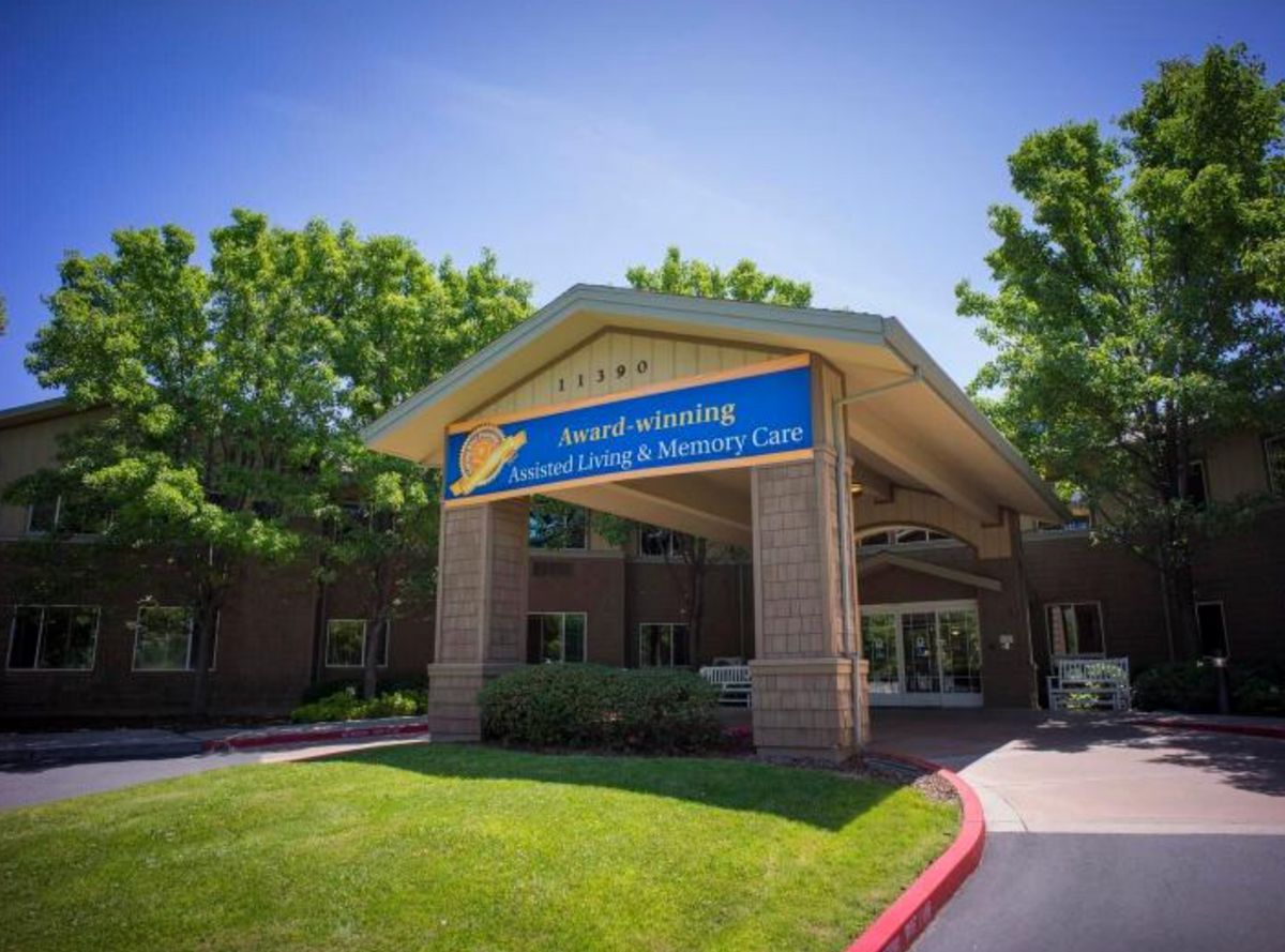 A building entrance with a prominent awning on a sunny day.