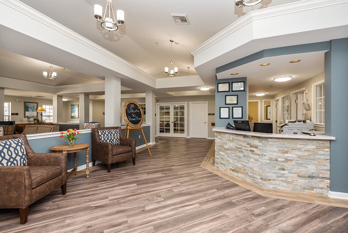 A modern lobby with a reception desk, comfortable seating, and stylish lighting fixtures.