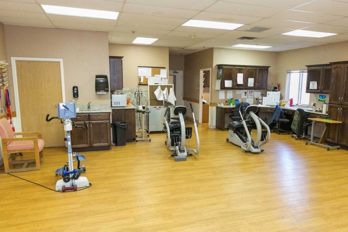 A rehabilitation center featuring various exercise equipment for physical therapy.