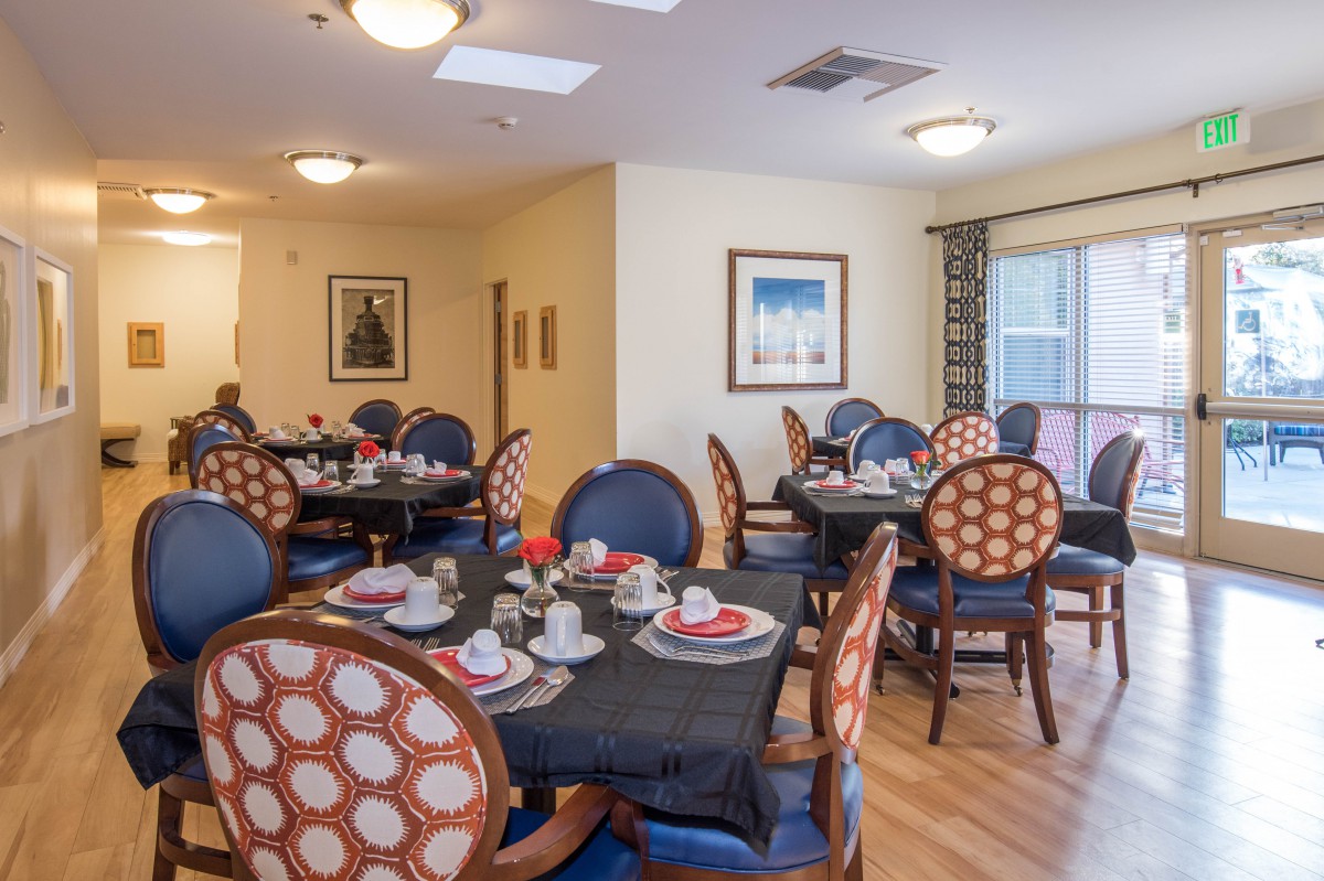 A cozy dining room with elegantly set tables and comfortable seating.