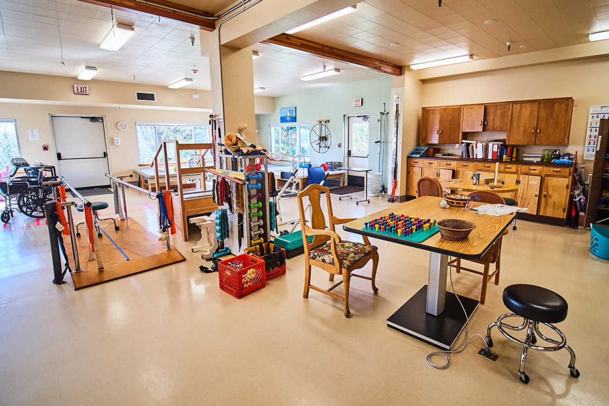 A rehabilitation center featuring various exercise and therapy equipment.