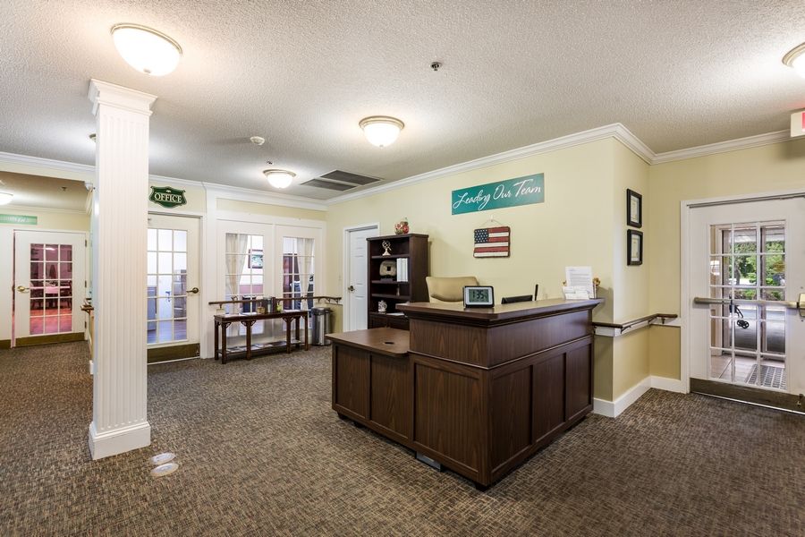 A welcoming office reception area with a central desk and comfortable furnishings.