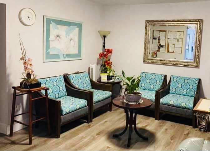 A cozy waiting room with comfortable chairs and decorative elements.
