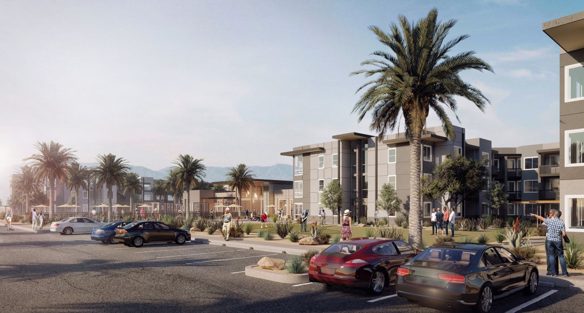 A modern building surrounded by palm trees and a parking lot filled with cars.
