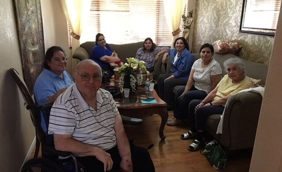 A group of people gathered in a living room for a casual visit.